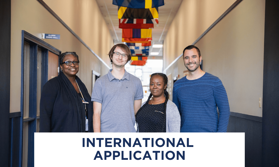 Group of faculty at Warner University in front of international flags.